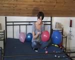 Smoking teen plays with many balloons