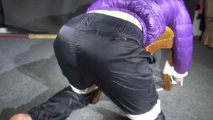 Watching Sonja wearig a sexy blue rainpant and a purple down jacket being tied, gagged and hooded on a stool with ropes and a cloth gag (Video)