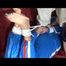 Pia tied and gagged by Sophie on the sofa wearing a shiny blue pvc suit(Video)