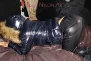 Watching Sandra wearing a sexy shiny nylon down pants and a sexy down jacket with coat lolling and posing for you on a sofa (Pics)