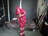 Watch Sandra beeing bound gagged and pantyhooded in her shiny nylon Rainwear