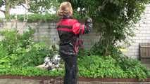 Watching sexy Sandra wearing sexy shiny nylon rainwear gardening outside (Video)