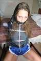 Stella being tied and gagged with ropes and a clothgag on a chair wearing a sexy shiny nylon short and a rain jacket (Pics)