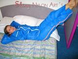 Katharina lolling on the bed wearing lightblue sexy shiny nylon rainwear (Pics)