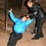 One archive girl tied and gagged by another archive girl outdoor wearing lightblue and black shiny downjackets (Pics)