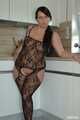 Chubby benita posing in a black bodystocking in the kitchen