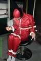 Watch Pia enjoying her Rainsuit bound and gagged on a Hairdresserchair