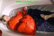 SEXY SONJA wearing a black shiny nylon rain pants and an orange big downjacket enjoying a bath (Pics)