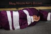 Sexy Sandra being tied, gagged and hooded with tape on the floor wearing a supersexy purple rain overall (Pics)