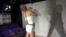 Watching sexy Sandra being tied and gagged with ropes and a ballgag overhead wearing shiny nylon shorts and a top (Video)