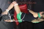 Watching sexy Sandra wearing a sexy green shiny nylon shorts and a black top being tied and gagged with ropes and a clothgag on a chair (Pics)