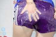 Sonja taking a shower wearing a very hot purple shiny nylon shorts and a blue rain jacket (Pics)