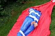 Nicole in an blue sauna suit tied and gagged in the garden (Pics)