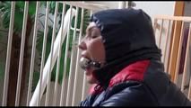 Jill tied, gagged and hooded with a bar on the stairway wearing a sexy oldschool downwear combination (Video)