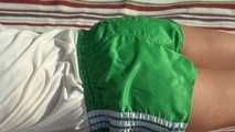 Watching sexy Sandra wearing a sexy green shiny nylon shorts and a white top taking a sun bath (Video9