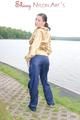 Enni posing outdoor on a lake wearing a supersexy blue shiny nylon rain pants and a golden rain jacket (Pics)