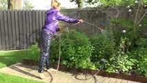 Watching sexy Sandra wearing a sexy blue rain pants and a purple rain jacket watering the flowers in the garden (Video)