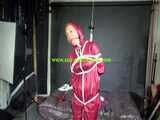 Watch Sandra beeing bound gagged and pantyhooded in her shiny nylon Rainwear