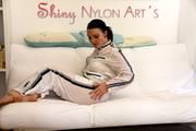 Jill posing and lolling on a sofa wearing supersexy white shiny nylon rainpants and rain jacket with hood (Pics)