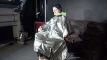 See Ronja tied and gagged on a Barber Chair in shiny nylon Rainwear and a shiny cape!