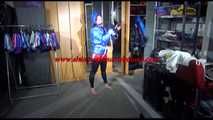 Sonja tied with ropes overhead and gagged with a clothgag wearing sexy black leather pants with a red shiny nylon shorts over it and a special blue down jacket (Video)