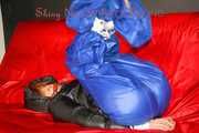 Sonja wearing a sexy blue shiny nylon raver pants and a black down jacket being tied and gagged with ropes on a sofa (Pics)