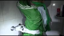 Sonja tied and gagged in a shower with tape and rope wearing a supersexy green shiny nylon shorts and rain jacket (Video)