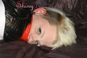 Sexy Courtney being tied and gagged with tape on a bed wearing black rainwear (Pics)