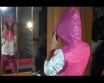 Lulu wearing a supersexy pink rain pants and a white/pink/purple rain jacket while posing in front of the mirror (Video)