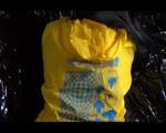 Lucy wearing a black shiny nylon shorts and a yellow rain jacket preparing the sofa for chilling (Video)
