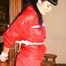 Jill tied and gagged on a pillar wearing a shiny red rainwear (Pics)