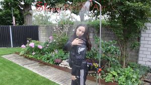 Watching Aiyana wearing a sexy black shiny nylon rainpant and a black shiny nylon down jacket trying the garden shower  (Pics)