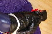 Alina tied and gagged in shiny down clothes