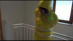 Jill tied and gagged on a stairrail wearing a sexy shiny yellow oldschool rainpants and rain jacket releasing herself (Video)