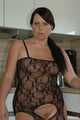 Chubby benita posing in a black bodystocking in the kitchen