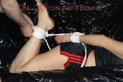 Sandra wearing a sexy black/red shiny nylon shorts and a black top being tied and gagged with ropes on a sofa (Pics)