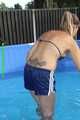 Watch Sandra cleaning the pool wearing a shiny nylon Shorts