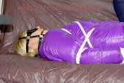 Pia tied and gagged with ropes and a ballgag with eye patches wearing a sexy crazy sensation down pants and a purple down jacket (Pics)