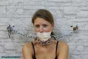 Heavy cuffed and gagged to the wall