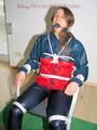 Katharina tied and gagged on a chair wearing shiny nylon rainwear and a raincape (Pics)