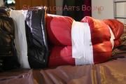 Mara tied, gagged and hooded with tape on bed wearing crazy sensation downwear in red/black (Pics)