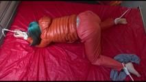 Mara tied and gagged on bed wearing a sexy orange shiny down jacket and a orange rain pants (Video)