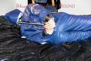 Pie tied and gagged with a bar on a bed wearing sexy blue shiny nylon AGU rainwear combination (Pics)