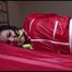 Jill tied and gagged on bed wearing a shiny light blue nylon shorts and a shiny red rain jacket (Video)