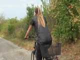 Watch Sandra riding her bike enjoying her shiny nylon Jumpsuit