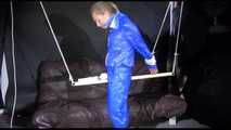 SUPERSEXY SANDRA wearing sexy shiny blue rainwear being tied and gagged overhead with ropes and a bar treated with a massager (Video)