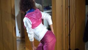 Lulu wearing a supersexy pink rain pants and a white/pink/purple rain jacket while posing in front of the mirror (Video)