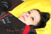 Lucy tied and gagged in a bed wearing a black shiny nylon downwear combination (Pics)