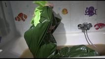 Mara wearing a sexy green shiny pvc jumpsuit with hood ties and gagges herself in a bath tub full of mud (Video)