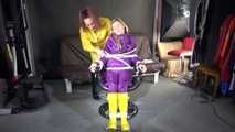 Watching sexy Sandra wearing hot purple shiny nylon rainwear with rubber boots being tied, gagged and hooded from Stella wearing a sexy yellow shiny nylon rainwear with high heels rubber boots (Video)